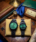 Rolex dupe couples black and green watches set with diamond dials on display